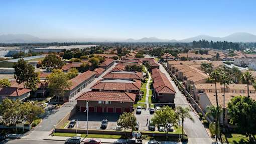 A large building complex with a parking lot in front.