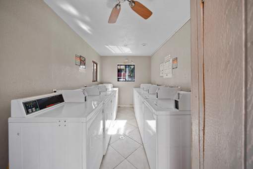 A row of washing machines in a laundromat.
