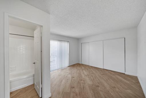 A room with a wooden floor and white walls.
