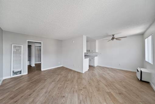 A room with a ceiling fan and a window.