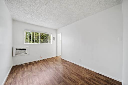 A room with a window and a fireplace.
