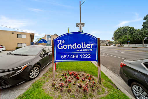 The Gondolier Apartments sign with a phone number on it.
