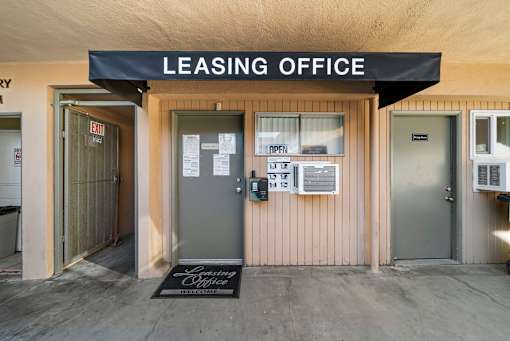 A leasing office with a sign on the door.