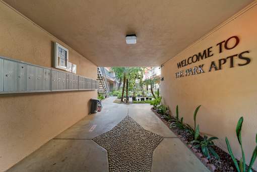 A hallway with a sign that says "Welcome to the Park Apts".
