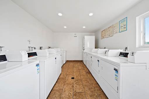 A laundromat with rows of washers and dryers.