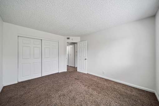 A room with carpeted floor and white walls.