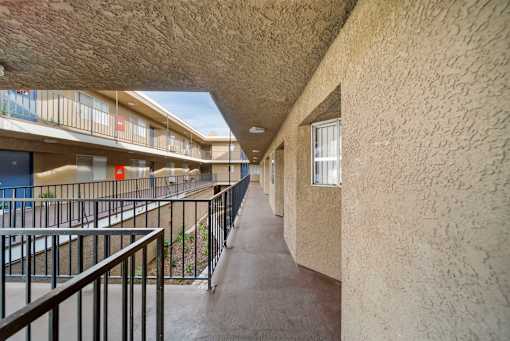 A long hallway with a balcony on the left side.