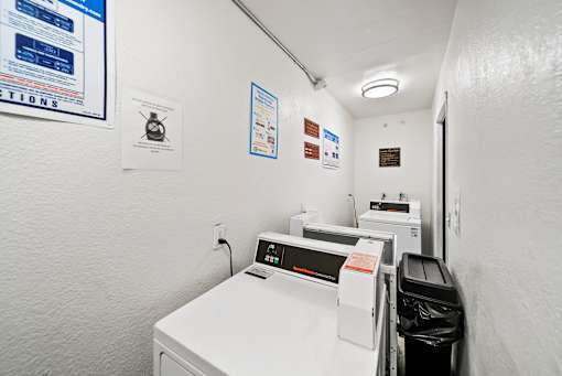 A white washing machine and dryer in a small laundry room.