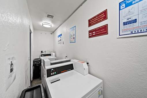 A white wall with a red sign and a blue poster.