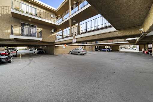 A parking garage with cars parked in it.