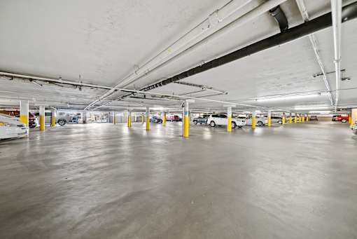 A spacious parking garage with concrete floors and multiple levels.