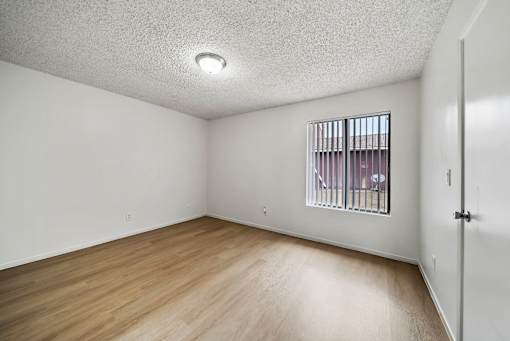 A room with a window and a door.