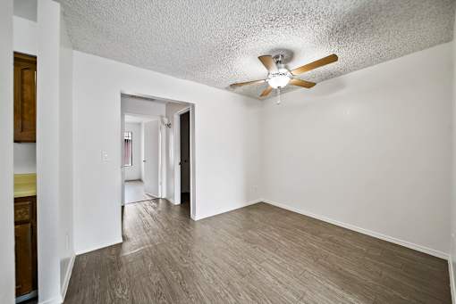 A room with a ceiling fan and light fixture.