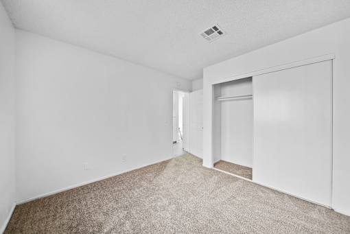 A room with carpeted floor and white walls.