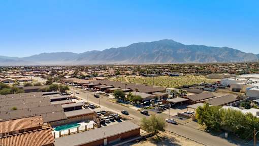 A view of a town with a mountain in the background.