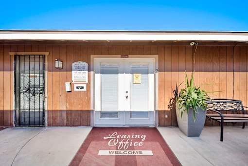 A building with a Leasing Office sign on the door mat.