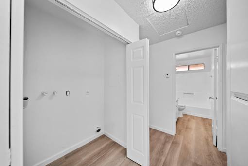 A white room with a door and a window.