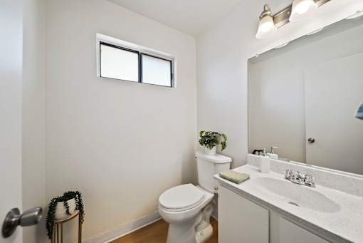A white toilet sits next to a sink in a small bathroom.