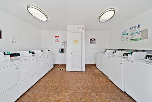 A laundromat with rows of washers and dryers.