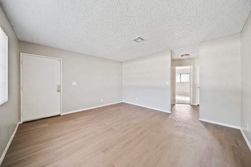 A room with wooden floors and white walls.