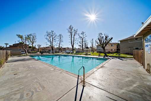A sunny day at a pool with a clear blue sky.