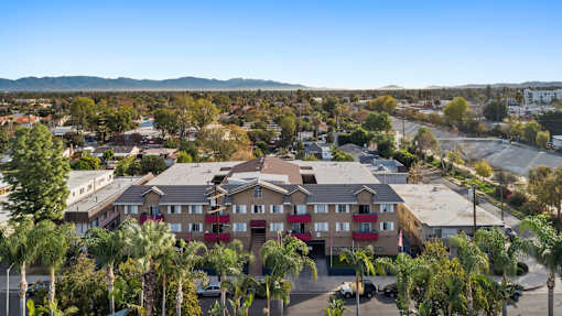 A residential area with apartment buildings and palm trees.