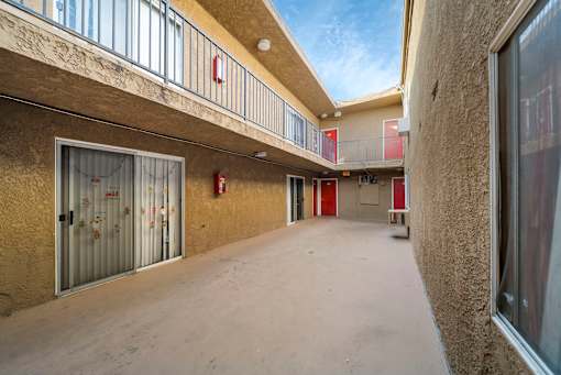 A long hallway with a fire extinguisher on the wall.