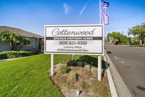 A sign for Cottonwood Spacious Apartment Homes with a leasing office at 8150 Cottonwood Ave.