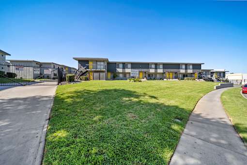 A modern building with a green lawn in front.