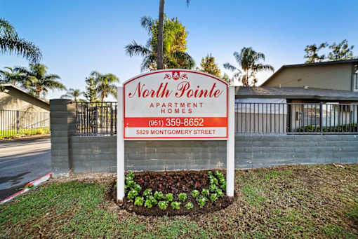 A sign for North Pointe Apartments is displayed in front of a building.