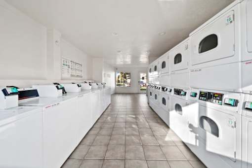 A row of washing machines in a laundromat.