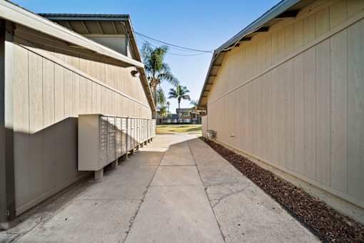 A long concrete walkway between two buildings.