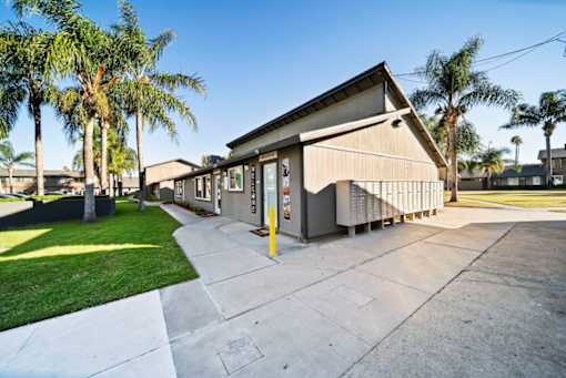 A building with a concrete walkway in front of it.