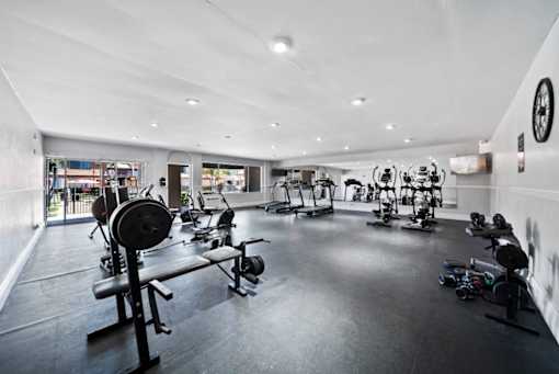 A gym with a variety of exercise equipment.