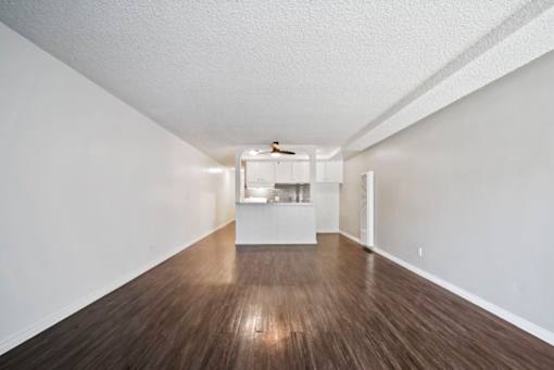 A room with wooden floors and white walls.