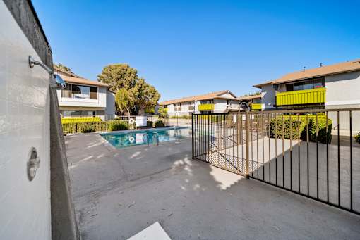 A black gate blocks the way to a pool.