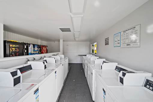 A laundromat with rows of washers and dryers.