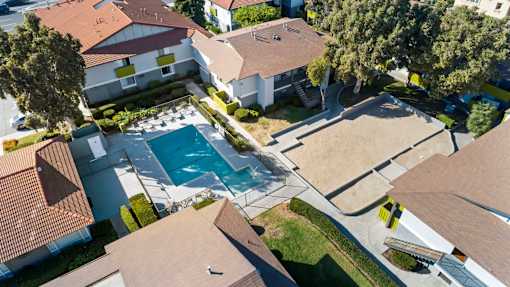 A swimming pool surrounded by houses.