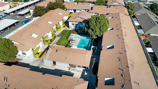 A view of a building with a pool in the middle.