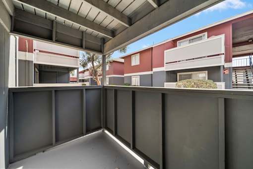 A modern building with a red and white facade and a grey roof.