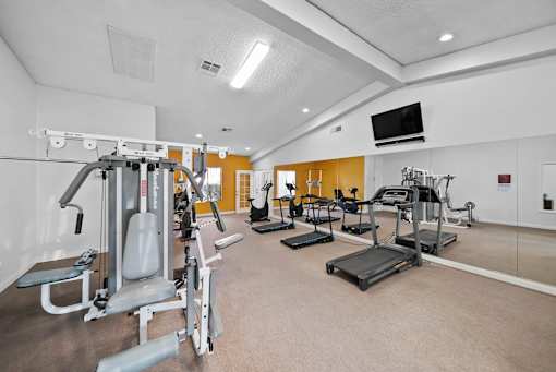 A well-equipped gym with various exercise machines.