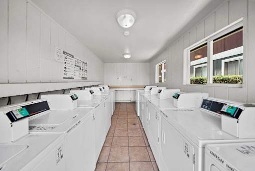 A laundromat with rows of washing machines.