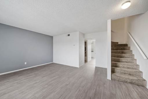 A room with a staircase on the right side.