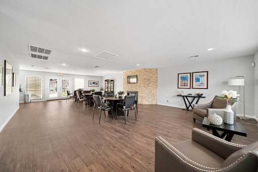 A spacious living room with a dining table and chairs.