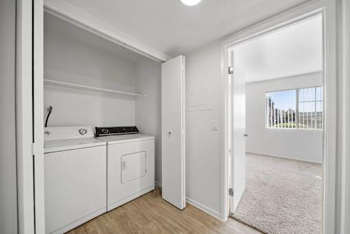 A white laundry room with a washer and dryer.