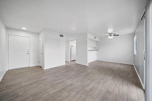A room with wooden flooring and white walls.