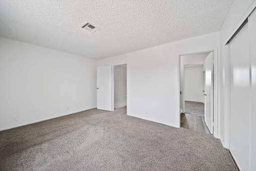 A room with white walls and carpeted floor.
