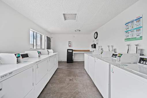 A laundromat with rows of washers and dryers.