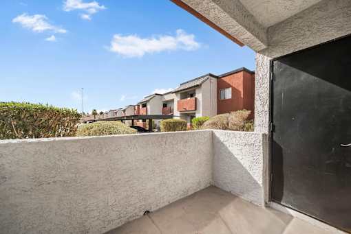 A balcony with a view of a row of houses.