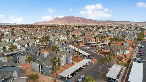 A residential area with houses and a mountain in the background.